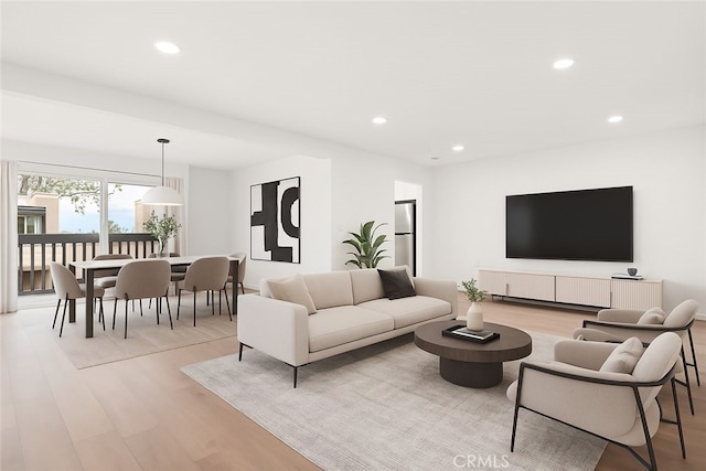 living area featuring light wood-style flooring and recessed lighting
