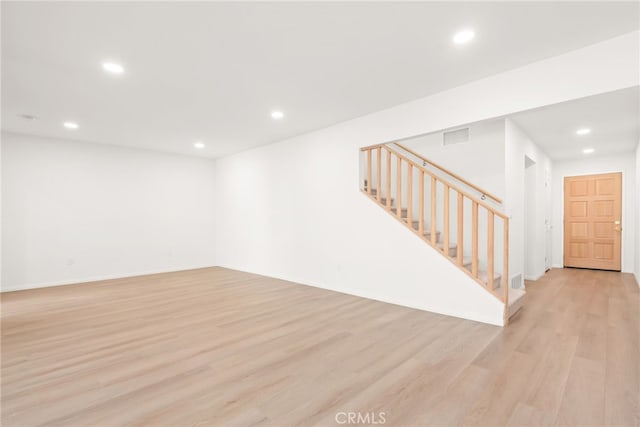 basement with visible vents, recessed lighting, light wood-style floors, and stairway