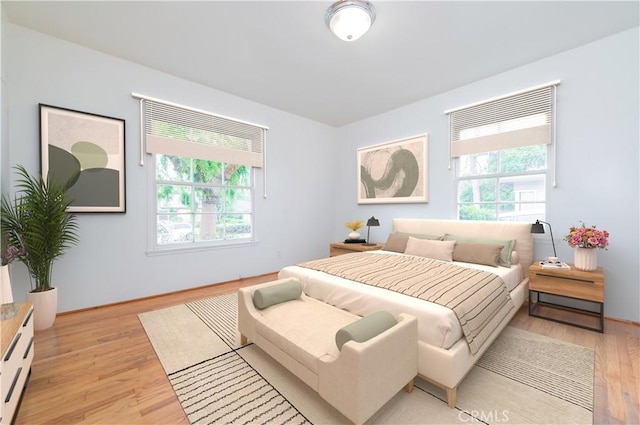 bedroom with multiple windows and light wood-type flooring