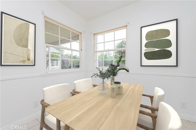 dining room with baseboards and tile patterned flooring