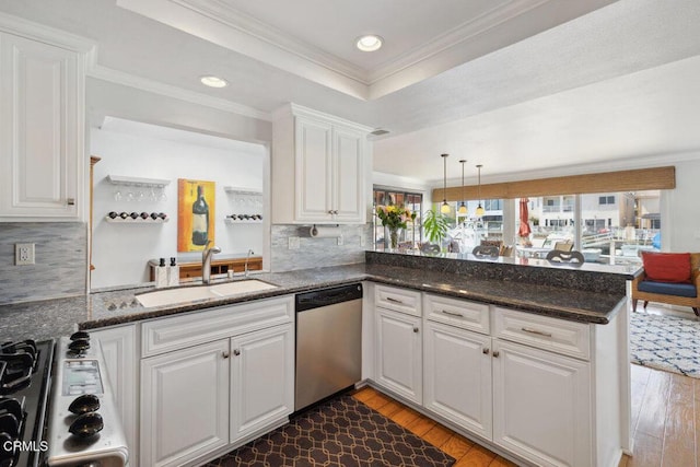 2231 Peninsula Rd, Oxnard, CA 93035 - kitchen with a sink, wood-type flooring, stainless steel dishwasher, a peninsula, and white cabinets