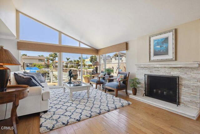 2231 Peninsula Rd, Oxnard, CA 93035 - living room with lofted ceiling, a fireplace, and hardwood / wood-style flooring