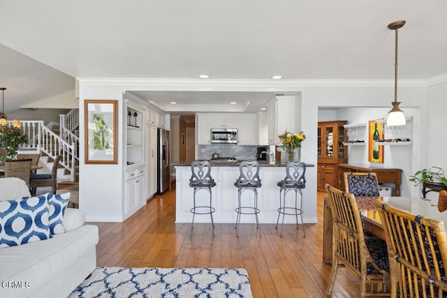 2231 Peninsula Rd, Oxnard, CA 93035 - living room featuring recessed lighting, crown molding, stairway, and light wood-type flooring