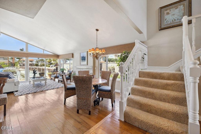 2231 Peninsula Rd, Oxnard, CA 93035 - dining room with stairway, high vaulted ceiling, hardwood / wood-style floors, and a chandelier