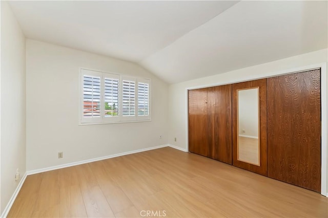 15705 Gila Way, Riverside, CA 92508 - unfurnished bedroom with a closet, baseboards, wood finished floors, and lofted ceiling