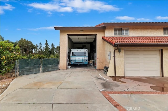 15705 Gila Way, Riverside, CA 92508 - view of front of house featuring a tiled roof, a garage, driveway, and stucco siding