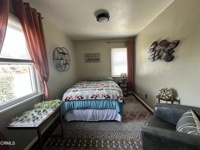 bedroom with carpet flooring and baseboards