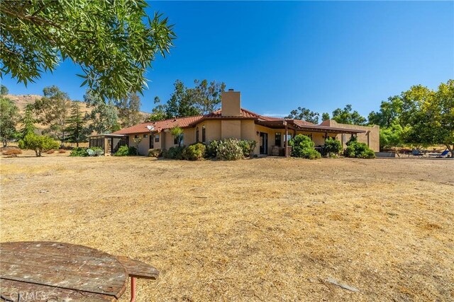 5420 Clayvale St, Acton, CA 93510 - view of front of house with a chimney, stucco siding, and a tile roof
