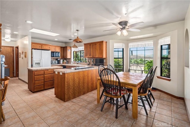 5420 Clayvale St, Acton, CA 93510 - dining room featuring light tile patterned floors, baseboards, recessed lighting, a skylight, and ceiling fan