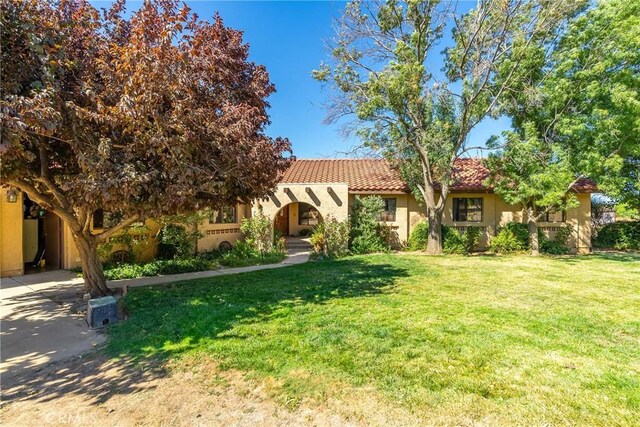 5420 Clayvale St, Acton, CA 93510 - view of front of home featuring a tile roof, stucco siding, and a front lawn