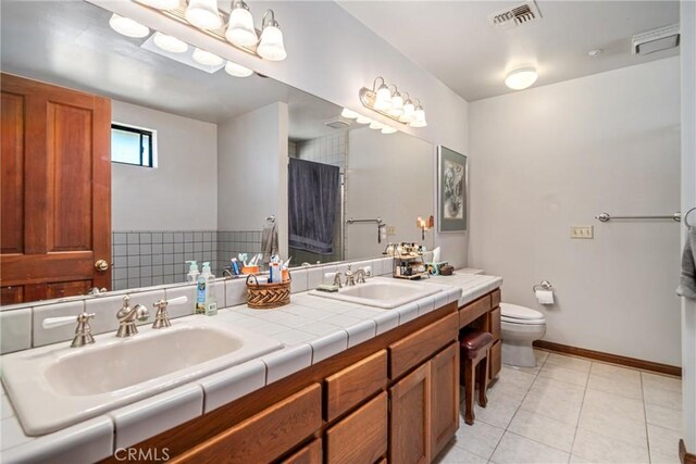 5420 Clayvale St, Acton, CA 93510 - bathroom with tile patterned floors, toilet, double vanity, and baseboards