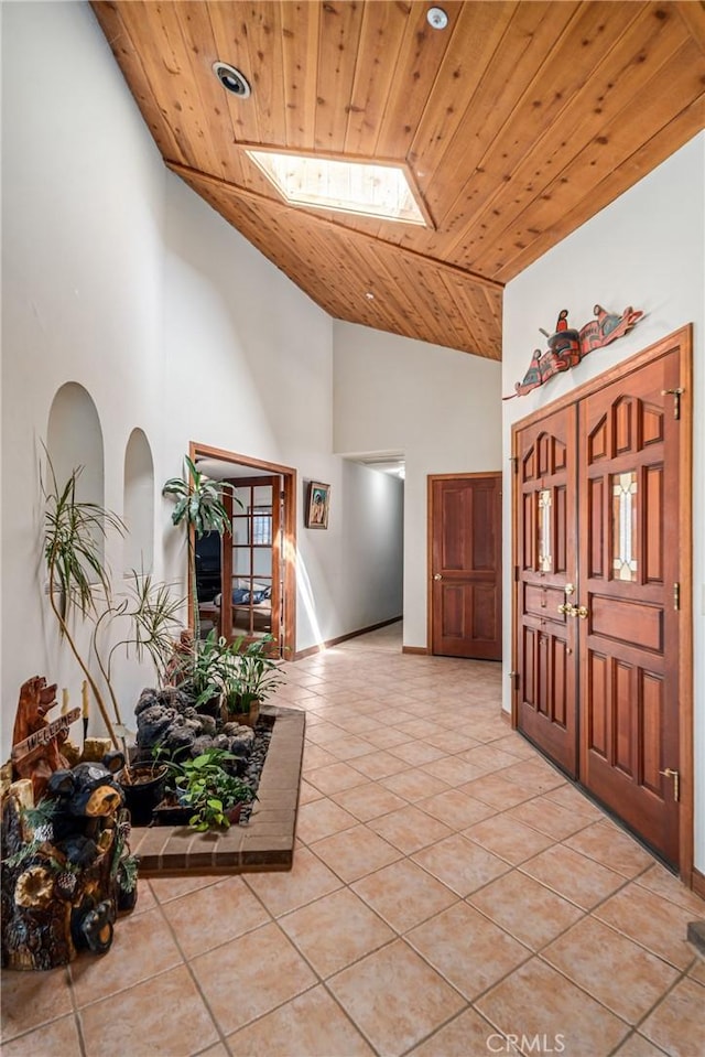 5420 Clayvale St, Acton, CA 93510 - entrance foyer featuring light tile patterned floors, high vaulted ceiling, a skylight, and wood ceiling