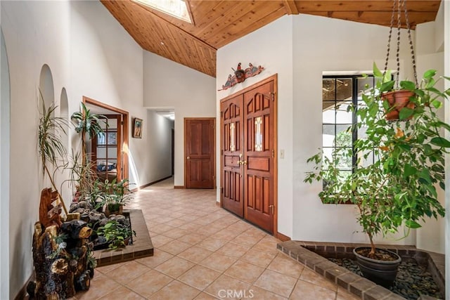 5420 Clayvale St, Acton, CA 93510 - entryway featuring wooden ceiling, light tile patterned floors, a skylight, high vaulted ceiling, and baseboards