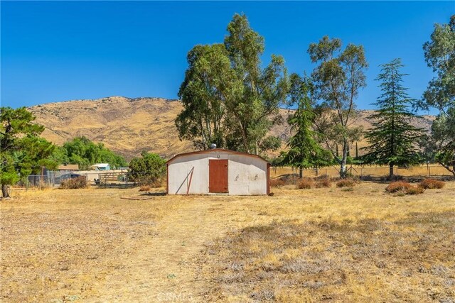 5420 Clayvale St, Acton, CA 93510 - view of yard featuring a storage shed, a mountain view, fence, an outbuilding, and a view of rural / pastoral area