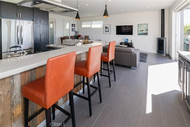 1204 Monterey Blvd, Hermosa Beach, CA 90254 - kitchen featuring freestanding refrigerator, wall chimney range hood, light countertops, a breakfast bar, and recessed lighting