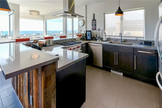 1204 Monterey Blvd, Hermosa Beach, CA 90254 - kitchen featuring stainless steel appliances, island range hood, light countertops, a peninsula, and hanging light fixtures