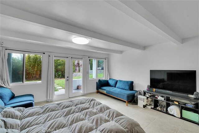 living room with french doors, tile patterned floors, and beamed ceiling