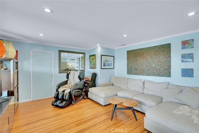 living area with crown molding, wood finished floors, and recessed lighting