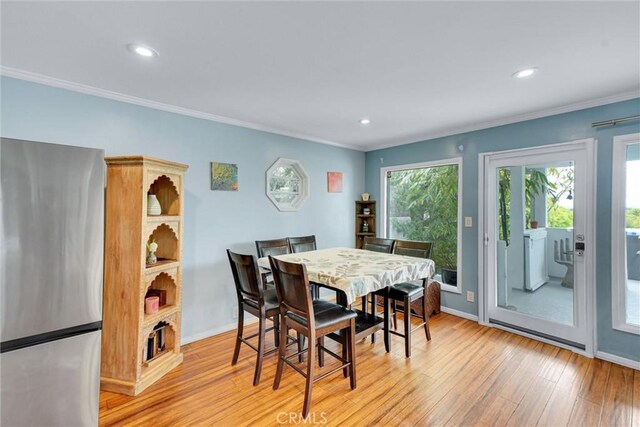 dining space featuring crown molding, light wood-style floors, and recessed lighting