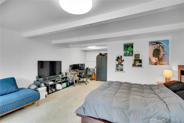 bedroom with light tile patterned flooring and beam ceiling