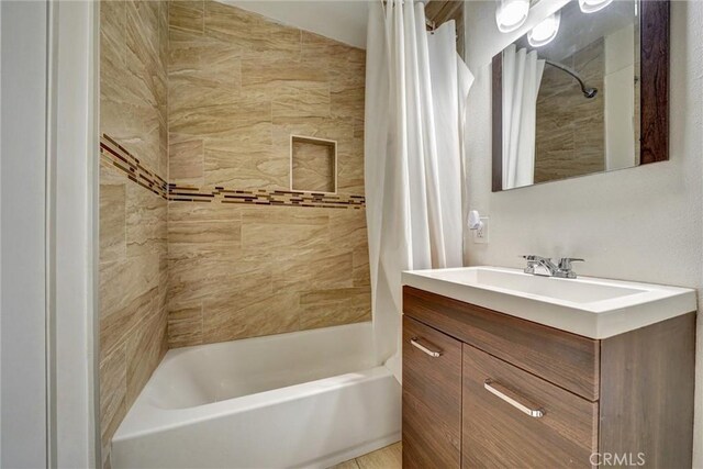 full bathroom featuring shower / bath combination with curtain and vanity