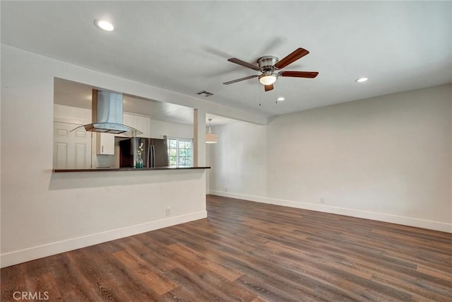 unfurnished living room with baseboards, dark wood-style flooring, and visible vents