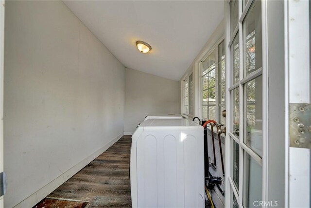 washroom featuring dark wood-style flooring, baseboards, washer and dryer, and laundry area