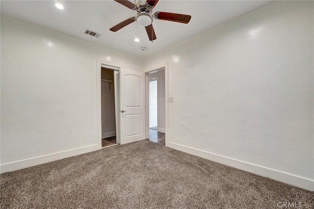empty room with dark carpet, baseboards, visible vents, ceiling fan, and recessed lighting