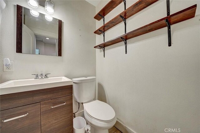 bathroom with toilet and vanity