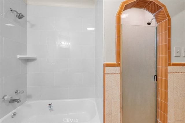 full bath with enclosed tub / shower combo and tile walls