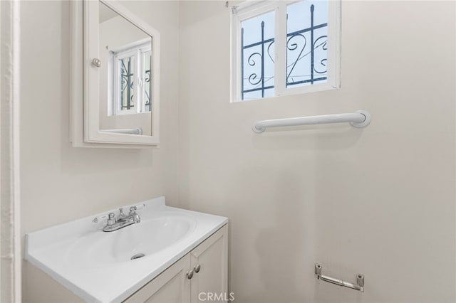 bathroom featuring a healthy amount of sunlight and vanity