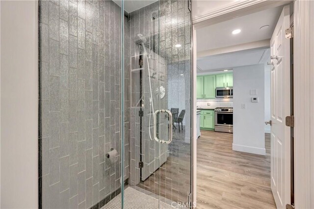 1 3rd Pl Unit 302, Long Beach, CA 90802 - full bathroom with a stall shower, wood finished floors, recessed lighting, vanity, and backsplash