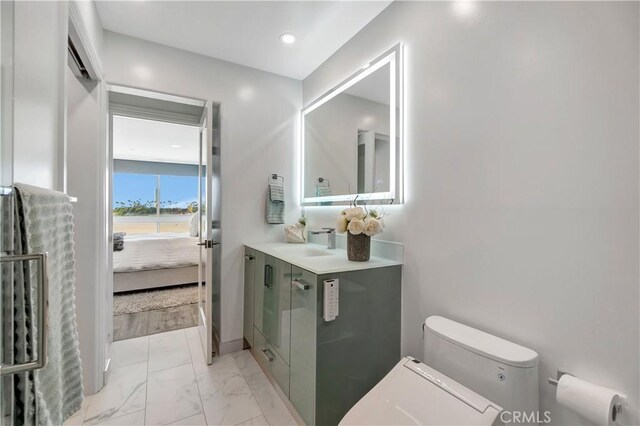 1 3rd Pl Unit 302, Long Beach, CA 90802 - ensuite bathroom featuring vanity, toilet, and marble look tiles