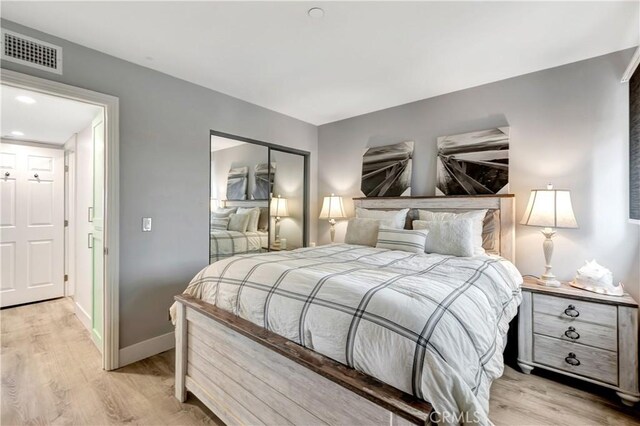 1 3rd Pl Unit 302, Long Beach, CA 90802 - bedroom with light wood finished floors, baseboards, and a closet