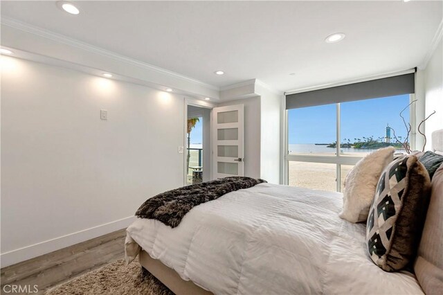 1 3rd Pl Unit 302, Long Beach, CA 90802 - bedroom with ornamental molding, wood finished floors, a water view, baseboards, and multiple windows