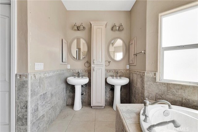 23073 Cielito Dr, Apple Valley, CA 92308 - full bathroom featuring tile walls, a bath, tile patterned floors, and wainscoting