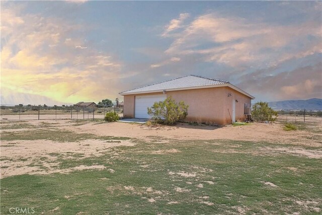 23073 Cielito Dr, Apple Valley, CA 92308 - view of side of property featuring stucco siding and a garage