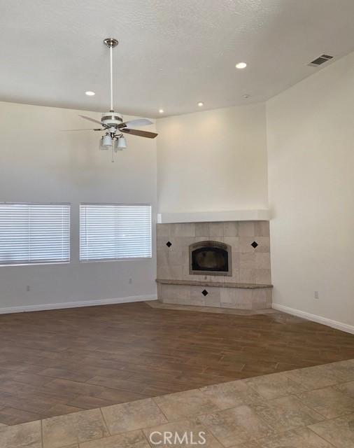 23073 Cielito Dr, Apple Valley, CA 92308 - unfurnished living room featuring wood finished floors, a ceiling fan, recessed lighting, and a fireplace