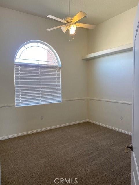 23073 Cielito Dr, Apple Valley, CA 92308 - unfurnished room featuring dark colored carpet and ceiling fan
