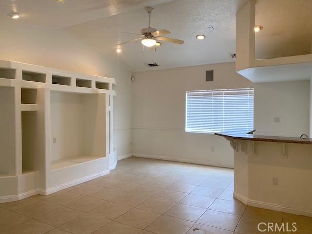 23073 Cielito Dr, Apple Valley, CA 92308 - spare room with lofted ceiling, ceiling fan, and light tile patterned floors