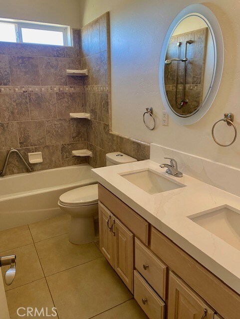 23073 Cielito Dr, Apple Valley, CA 92308 - bathroom with double vanity, tile patterned floors, and shower / bath combination