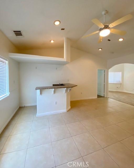 23073 Cielito Dr, Apple Valley, CA 92308 - kitchen featuring lofted ceiling, light tile patterned floors, recessed lighting, and ceiling fan