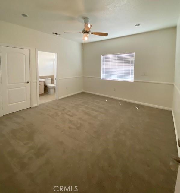 23073 Cielito Dr, Apple Valley, CA 92308 - unfurnished bedroom with carpet, ensuite bathroom, and a ceiling fan