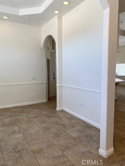 23073 Cielito Dr, Apple Valley, CA 92308 - empty room featuring arched walkways and recessed lighting