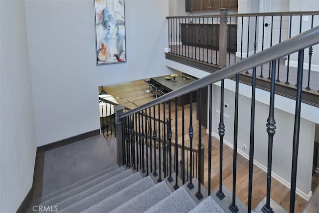 14608 Mccormick St, Sherman Oaks, CA 91411 - stairs with baseboards and wood finished floors