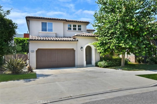 14608 Mccormick St, Sherman Oaks, CA 91411 - mediterranean / spanish house with concrete driveway, stucco siding, a garage, and a tile roof