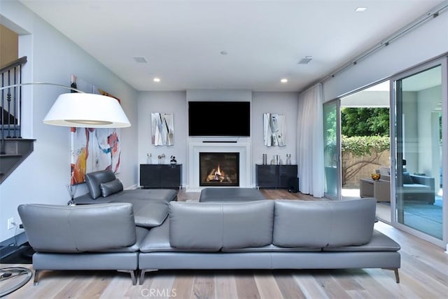 14608 Mccormick St, Sherman Oaks, CA 91411 - living area with wood finished floors, a glass covered fireplace, and recessed lighting
