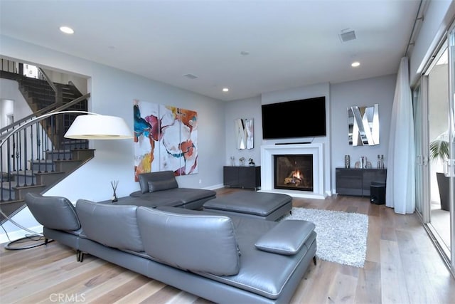 14608 Mccormick St, Sherman Oaks, CA 91411 - living room with wood finished floors, stairs, a lit fireplace, and recessed lighting