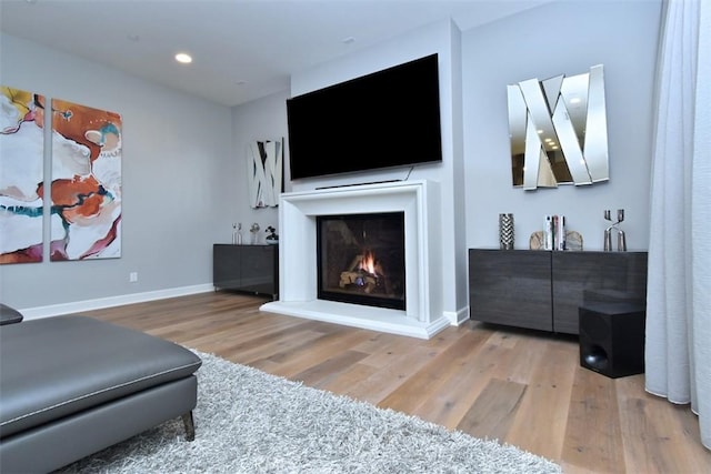 14608 Mccormick St, Sherman Oaks, CA 91411 - living room featuring wood finished floors, a lit fireplace, baseboards, and recessed lighting