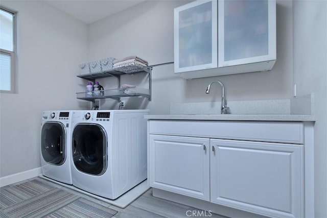 14608 Mccormick St, Sherman Oaks, CA 91411 - laundry area featuring washer and dryer, cabinet space, baseboards, and light wood-style flooring